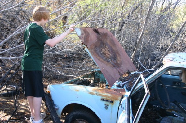 Nicholas checking under the hood of Melanies new car... it's a 4 cylinder.